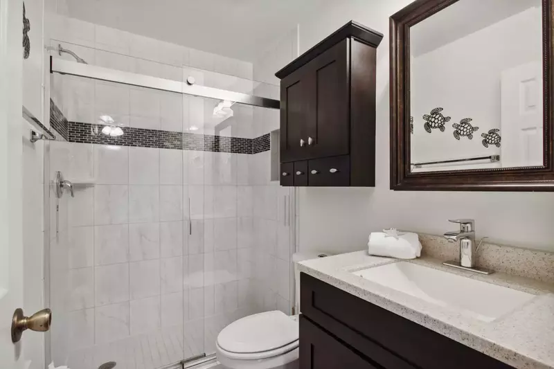 Updated tiled walk-in shower in guest en suite bath