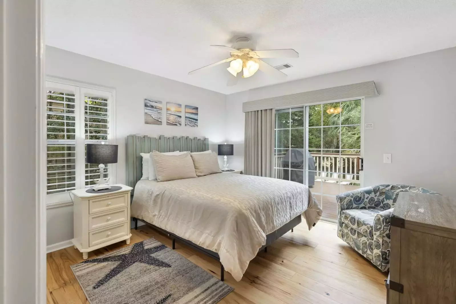 Guest bedroom with doors to back deck overlooking the pool.