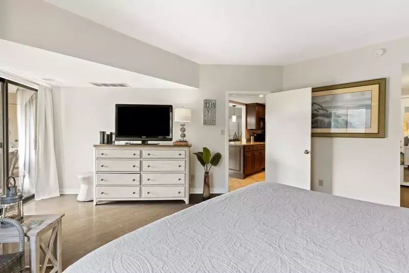 Primary bedroom with door out to private balcony