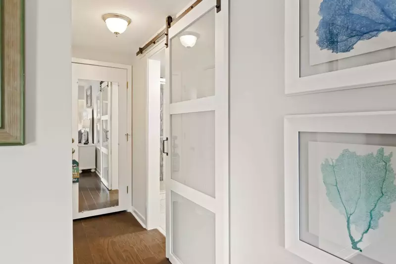 Barn door leading to en suite bath in primary bedroom