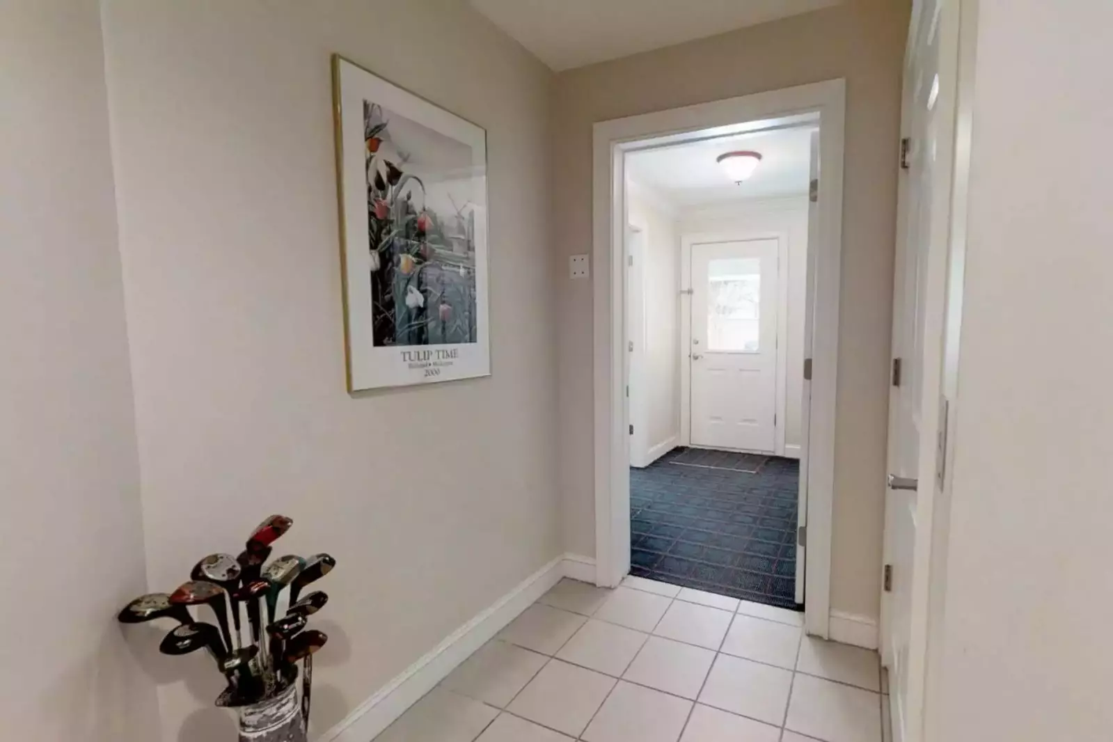 The ground level hallway leads to the garage, game room, pool, elevator and stairs to the second level