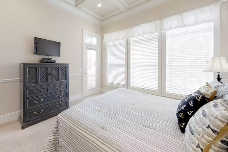 Second level guest bedroom (#2) with access to outdoor balcony