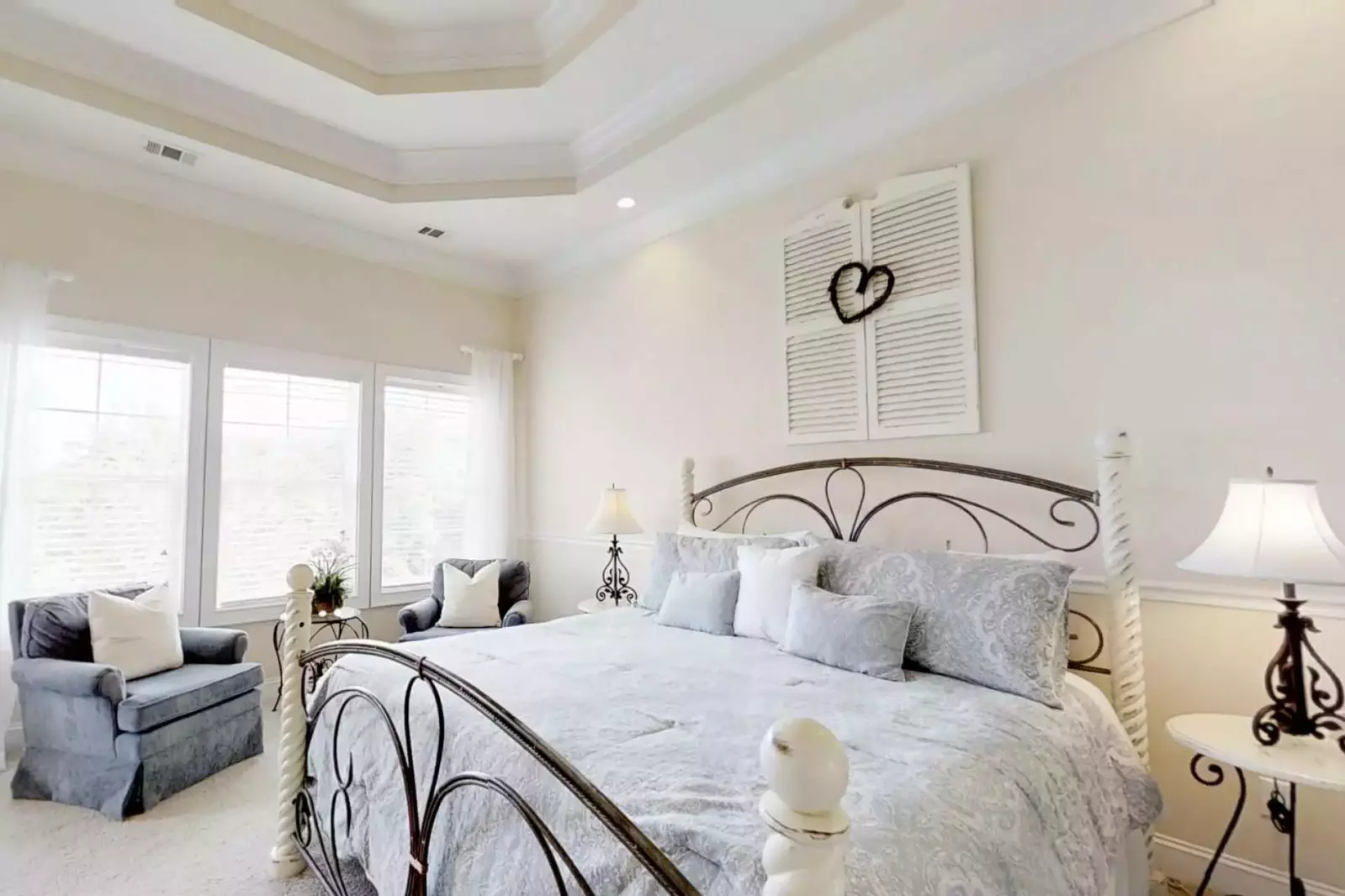 Master suite with king size bed, ceiling fan and dresser