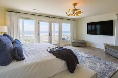 The primary suite has nearly wall-to-wall ocean views and a covered balcony to take in the salty sea breezes.