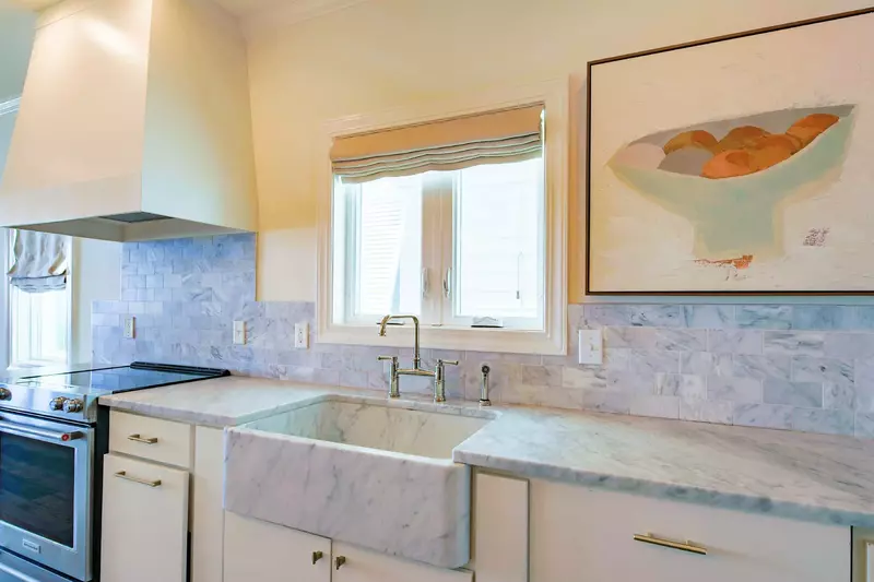 The kitchen features quartz counters, a deep sink and stainless steel appliances.