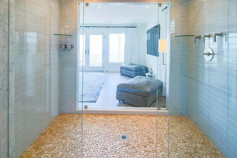 Enjoy ocean views from the tiled, walk-in primary suite shower!