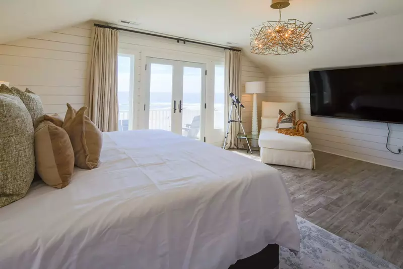 The king suite, which is located on the third floor, features a king bed, ocean views and shiplap walls.