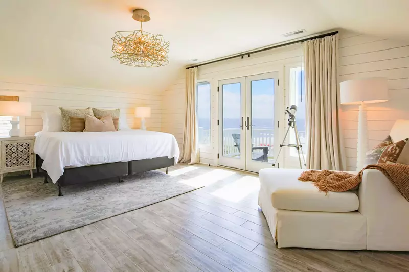 The king suite features access to a balcony with ocean views.