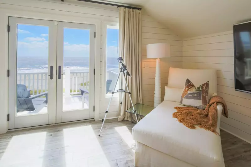 The king suite also features a chair, wall-mounted TV and floor lamp.