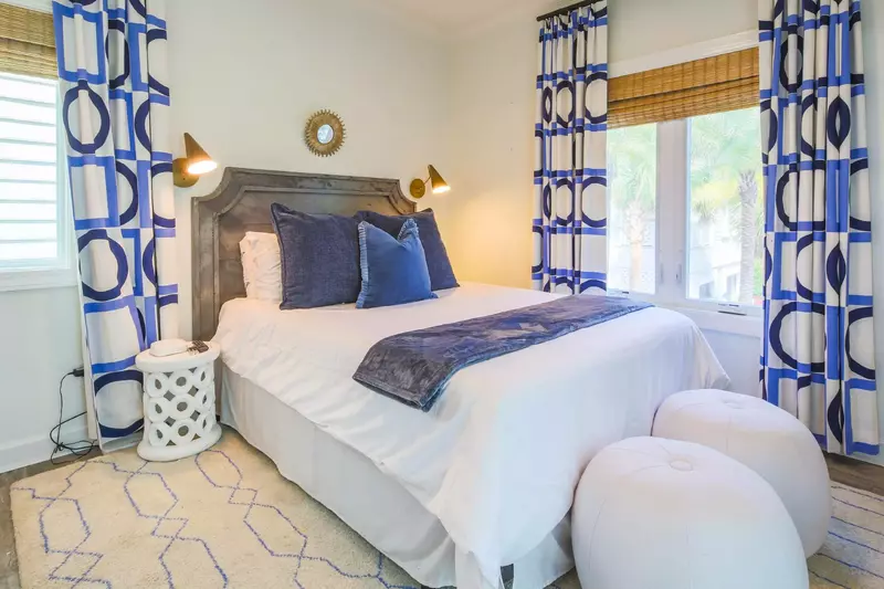 The queen suite features a queen bed with wall sconces.