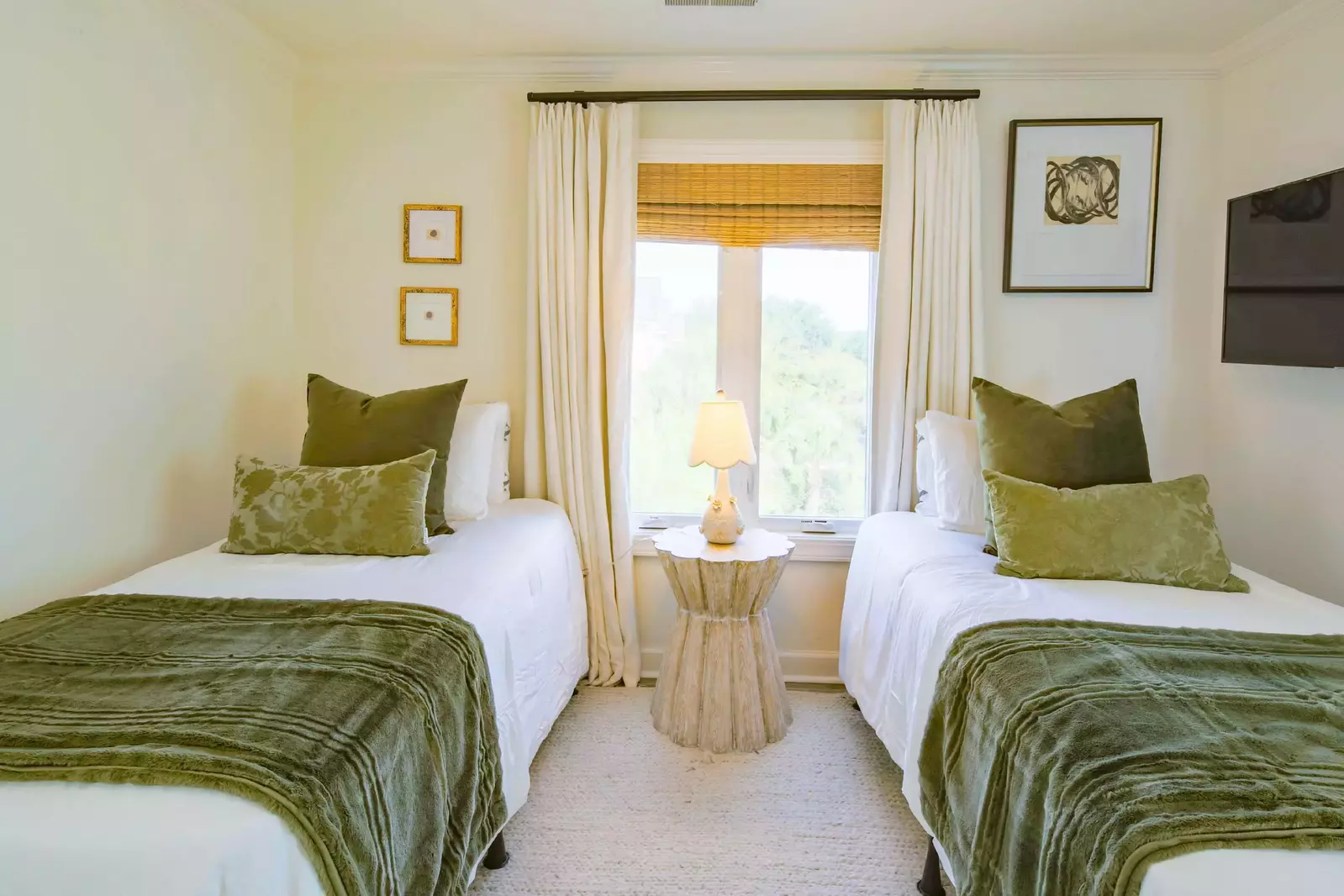 The two twin beds are separated by a night stand with a reading lamp.