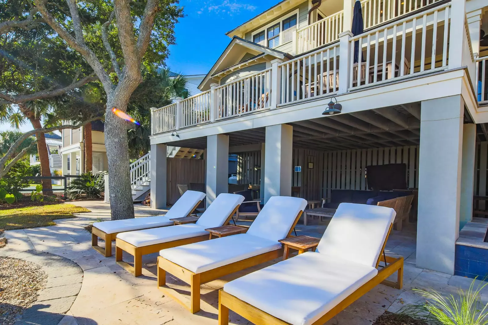 The patio area also has four sun loungers and a wall-mounted TV.