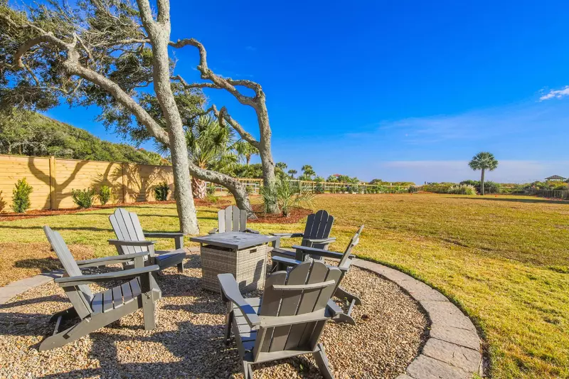 There are Adirondack seating areas in the backyard.