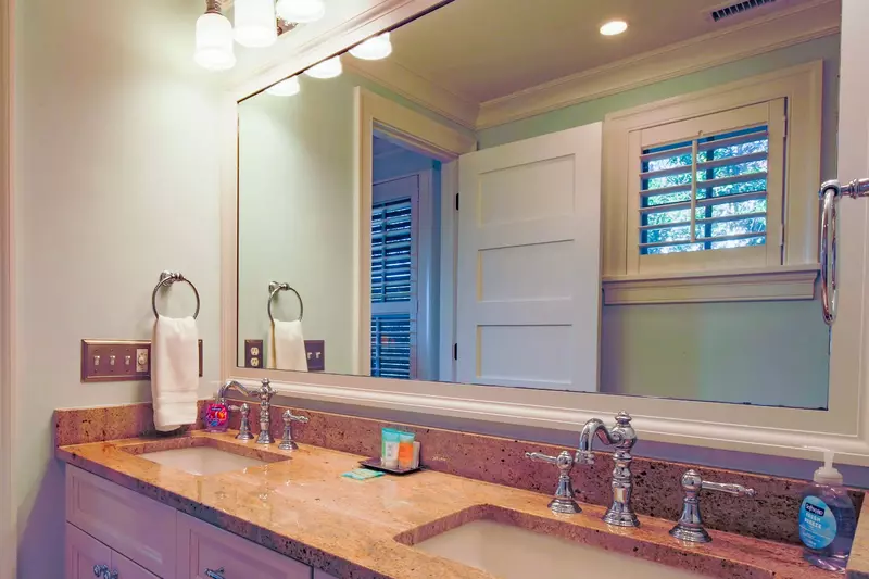 The en suite bathroom for the lower level master suite has a double sink vanity.