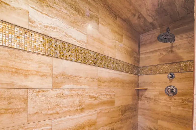 The en suite bathroom for the lower level master suite has a walk-in shower.