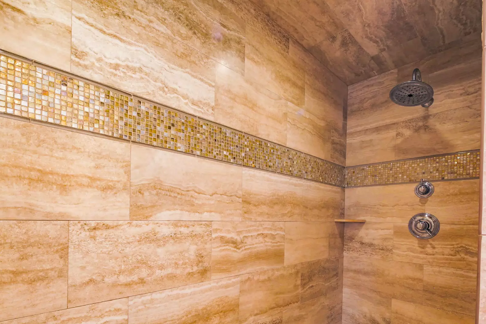 The en suite bathroom for the lower level master suite has a walk-in shower.