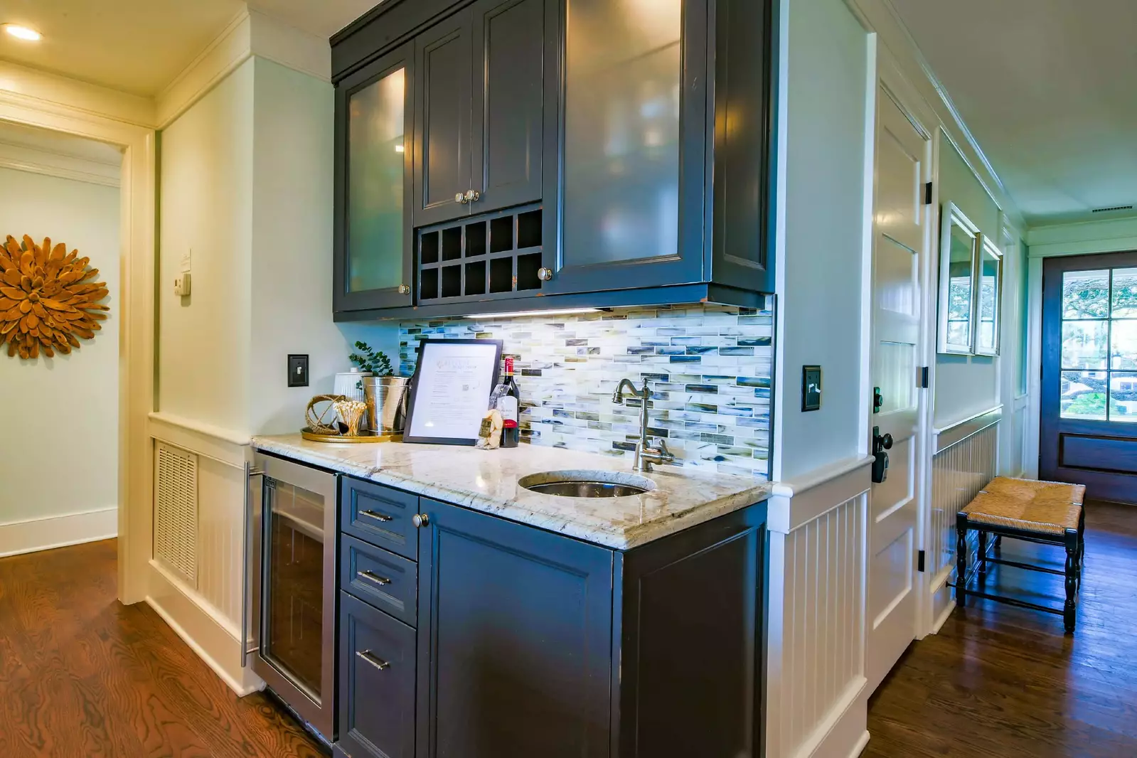 There is a guest suite and laundry room located down the hall near the butler's pantry.