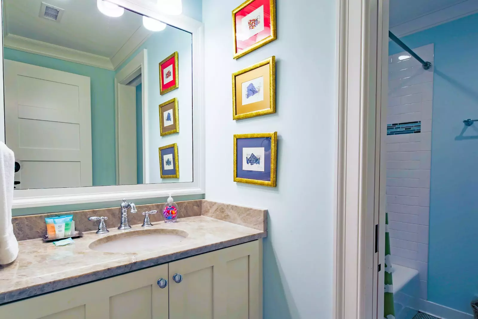 The en suite bathroom for this lower level guest suite features a shower/tub combo.