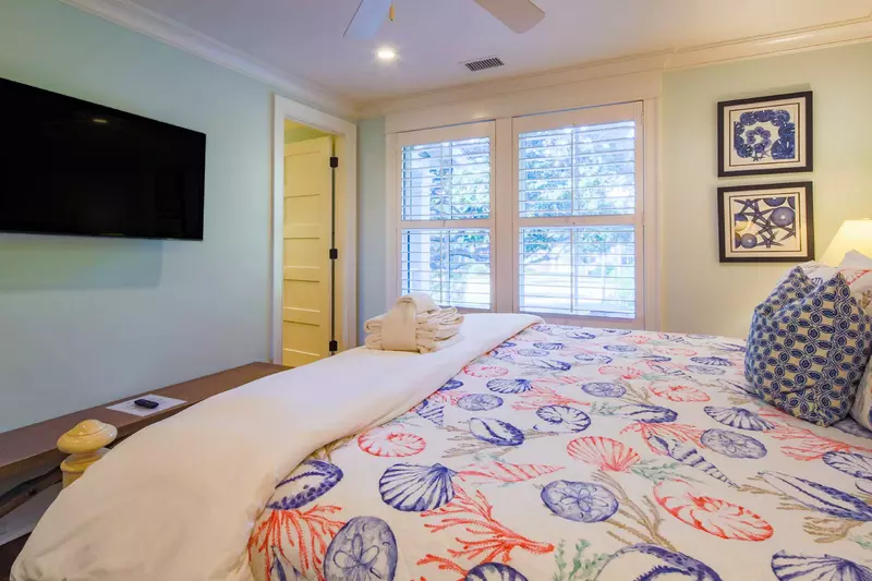 This guest suite also has a mounted smart TV and en suite bathroom.