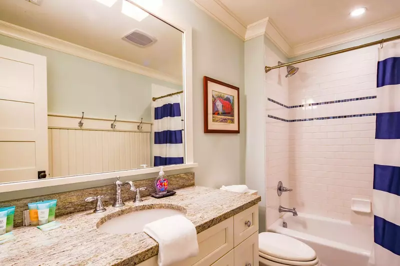This second floor bathroom features a spacious vanity and a shower/tub combo.