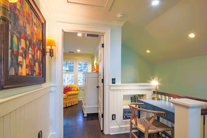 There is a desk at the top of the stairs on the second floor.