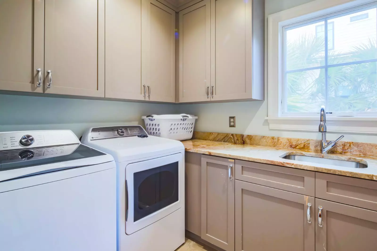 There's a full laundry room with washing machine, dryer and a utility sink on the home's lower level.