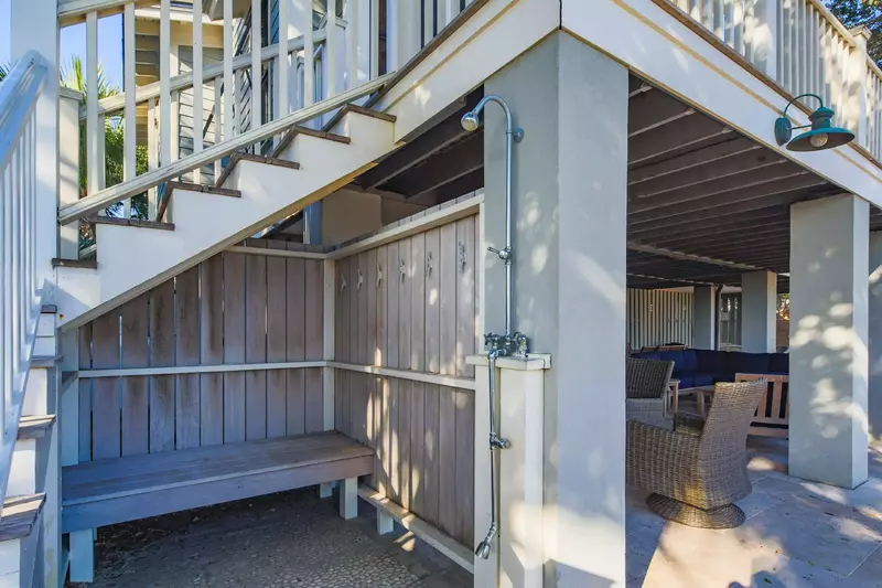 There is an outdoor shower located near the patio.