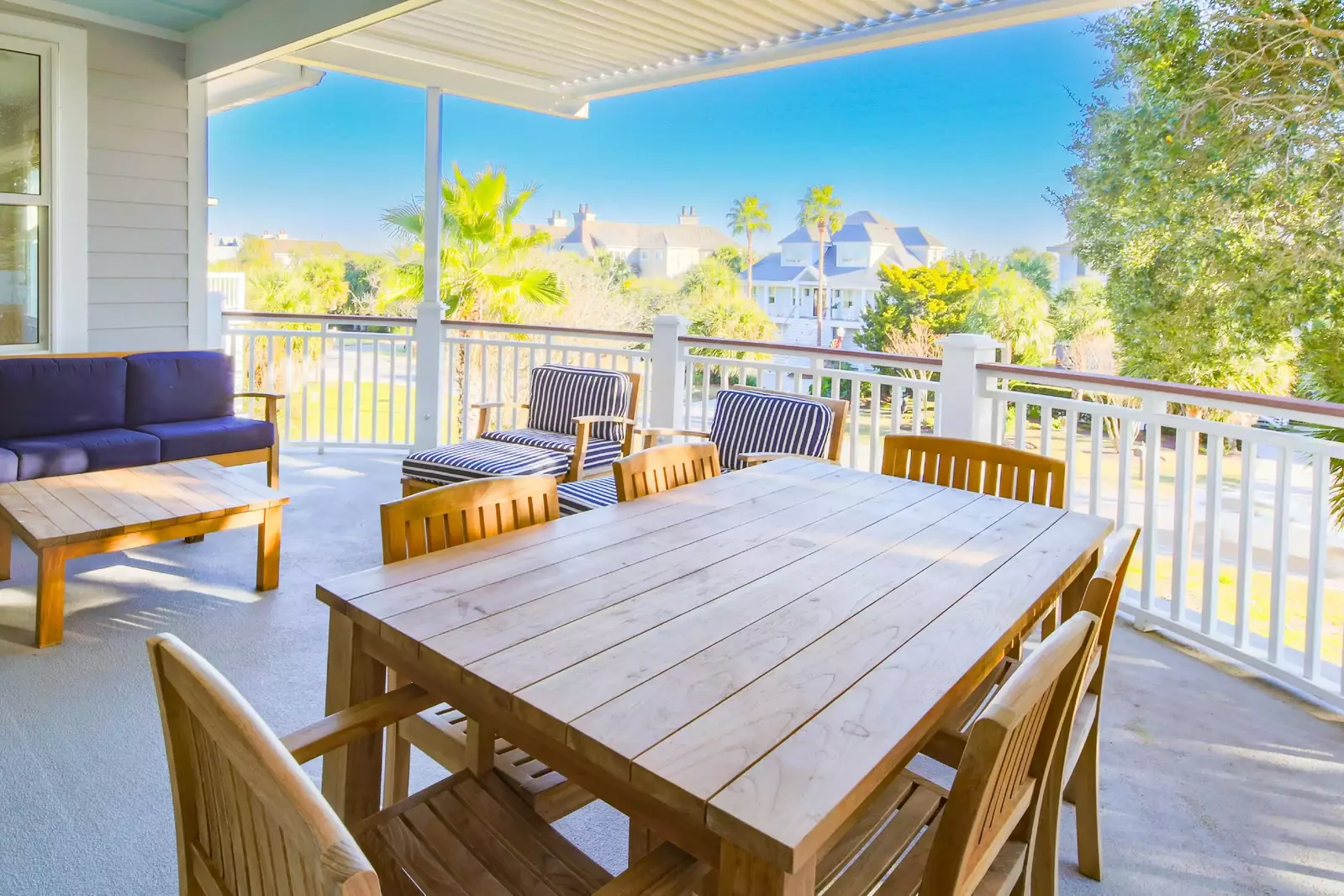This covered balcony off of the dining room and living room has ocean views & salty sea breezes.