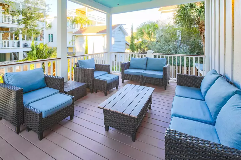 This back deck is located off of the first floor den and it overlooks the backyard pool.
