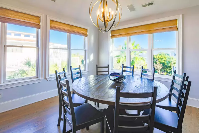 The dining table seats 10 and there are additional stools at the kitchen counter.