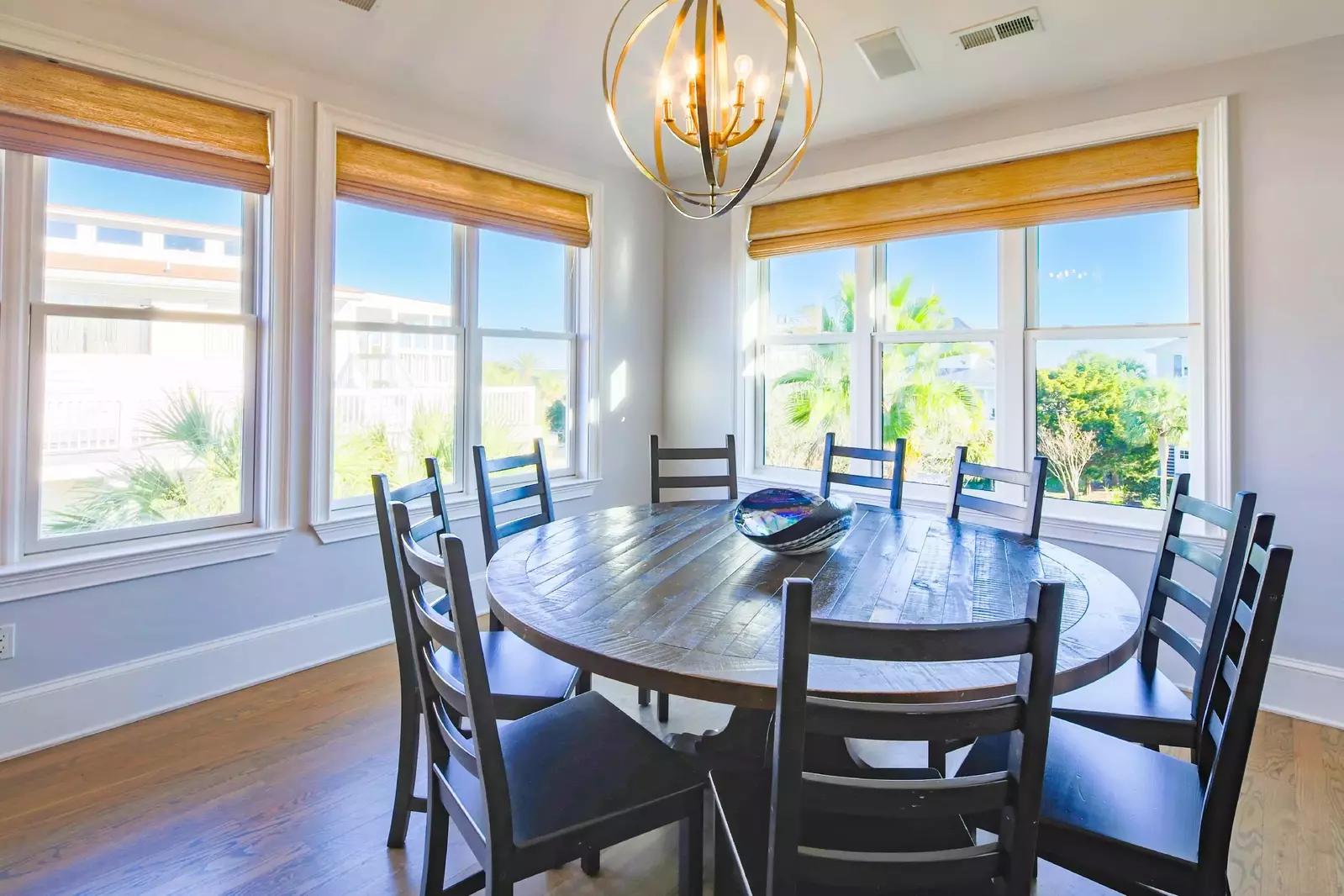 The dining table seats 10 and there are additional stools at the kitchen counter.