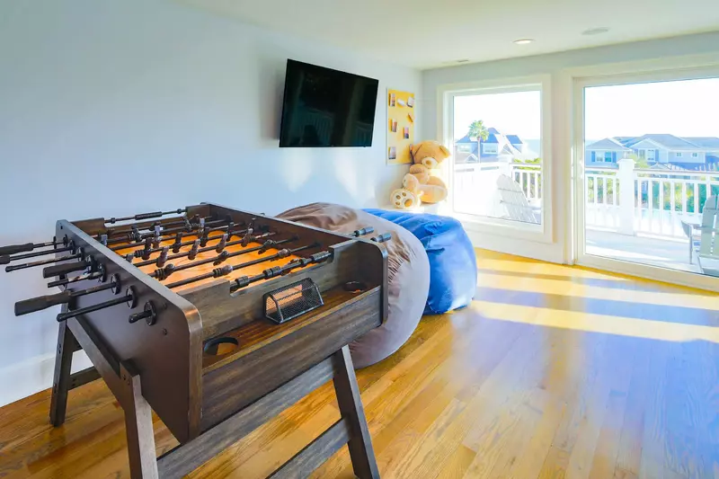 There is a foosball table and giant bean bag chairs in the third floor game room.