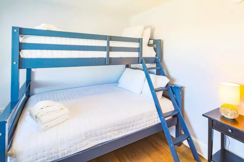 This bunk bedroom -- with a full and twin beds -- is located on one side of the game room.