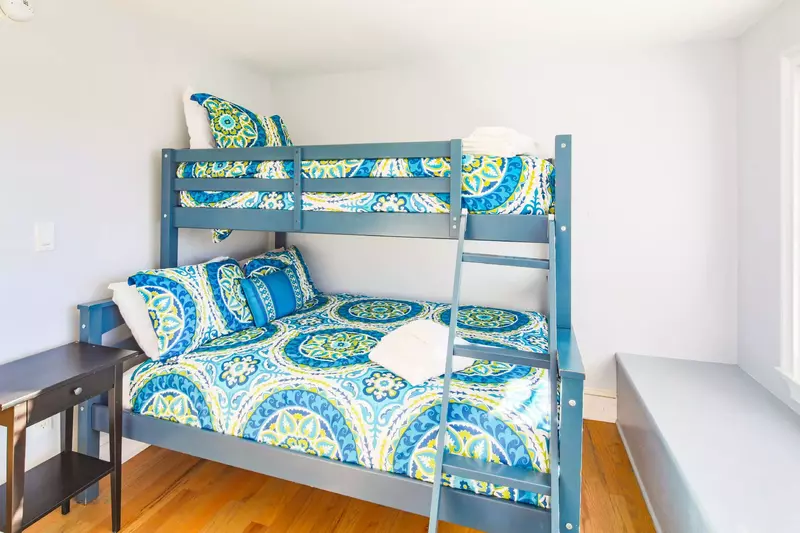 This bunk bedroom -- also with a full and twin beds -- is located on the other side of the game room.