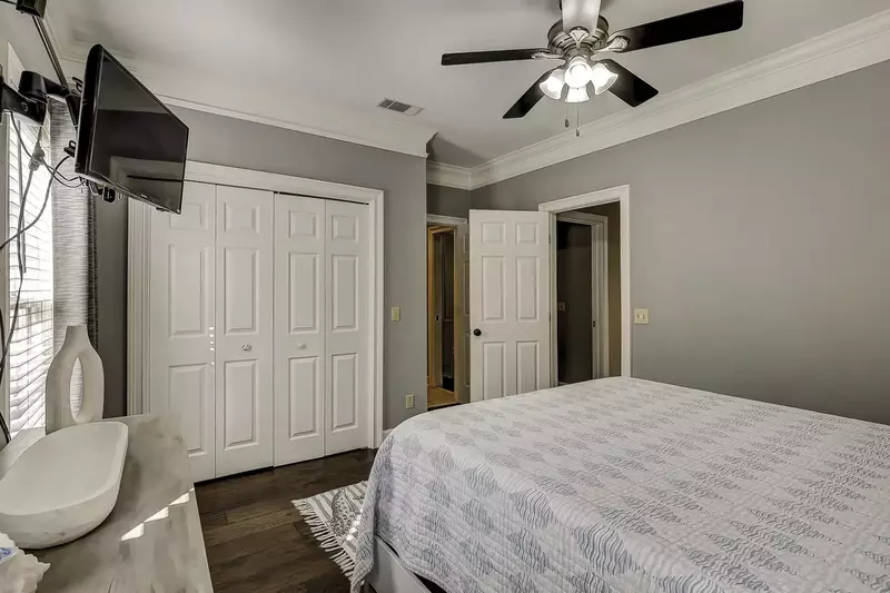 Large closet, ceiling fan and TV in guest bedroom