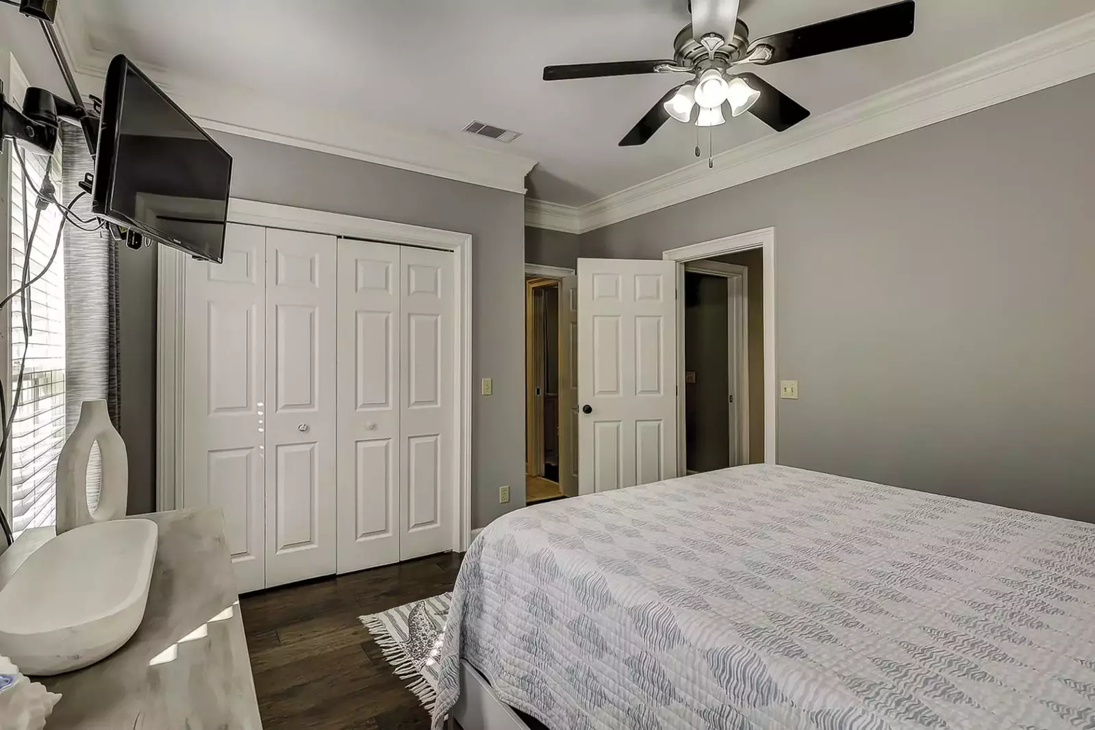 Large closet, ceiling fan and TV in guest bedroom