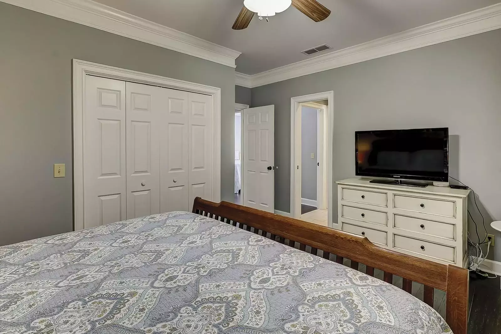 Guest bedroom, large closet, ceiling fan, TV and door way to jack & Jill bathroom