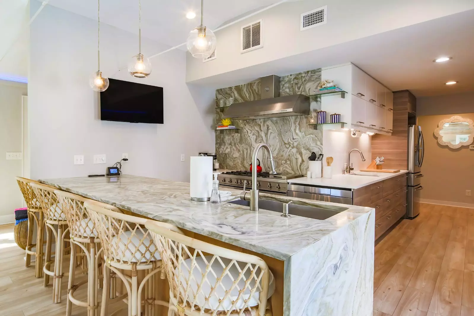 The gorgeous kitchen features granite counters & backsplash, stainless steel appliances and stool seating at the counter.