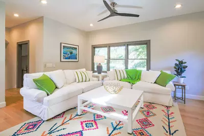 This cosy & cheery family room is located adjacent to the staircase to the 3 guest bedrooms and the screened porch.