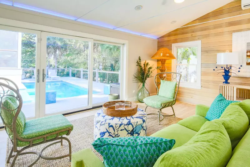 When you enter the front door, you will find the stylish living room with vaulted ceilings and sliding door access to the private pool deck.