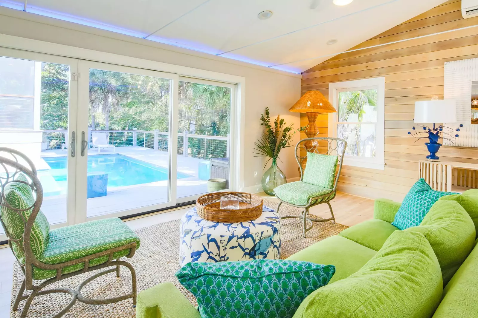 When you enter the front door, you will find the stylish living room with vaulted ceilings and sliding door access to the private pool deck.