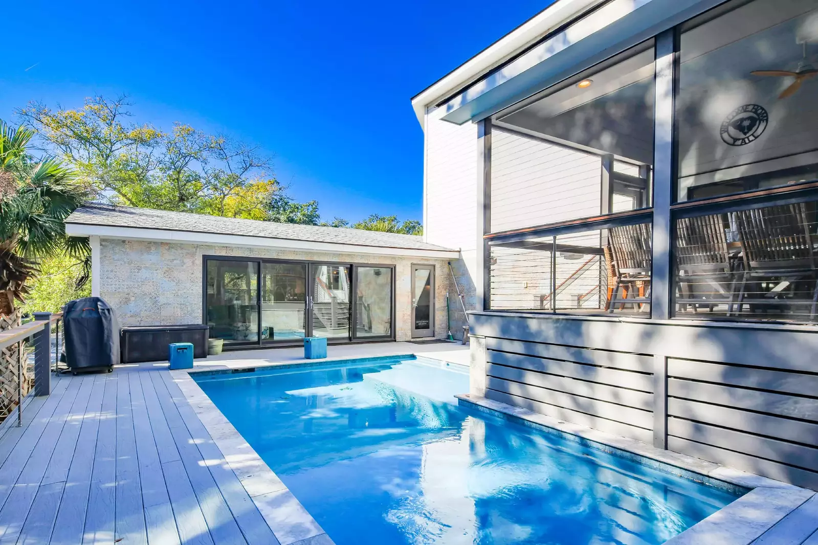 The screened porch overlooks the private pool and pool deck.