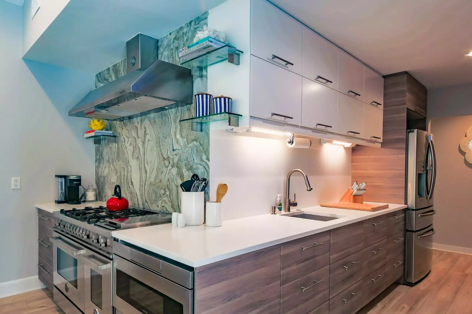 The kitchen also features a 6-burner gas range with a griddle and double oven, a microwave and refrigerator.