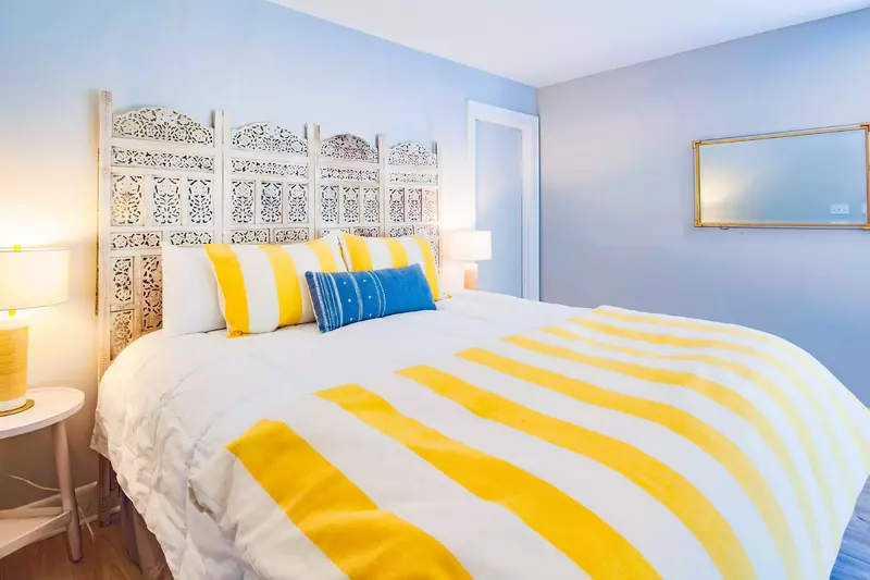 The primary suite features a king bed and night stands with reading lamps.