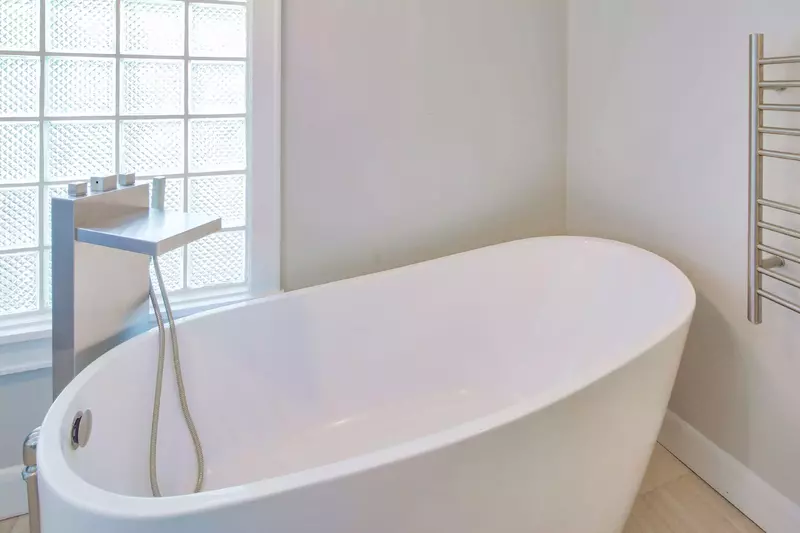 The en suite bathroom also features a soaking tub and towel warmer.