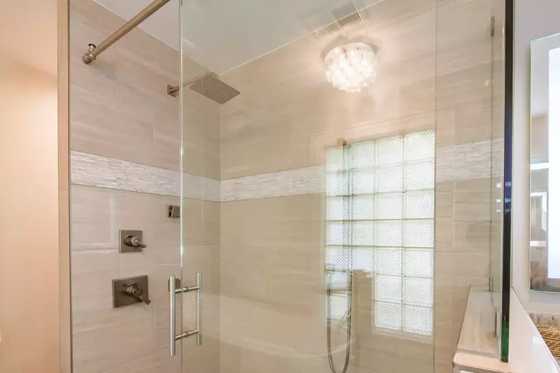 The en suite bathroom also has a beautifully-tiled, walk-in shower with two showerheads and body jets.