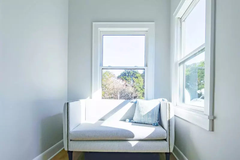 You'll find this sunny love seat at the top of the stairs near the three guest bedrooms on the home's upper level.