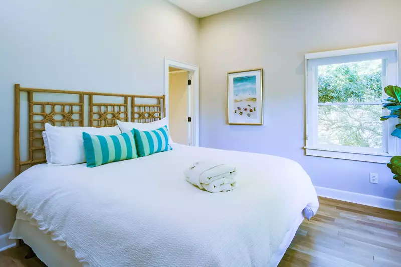 The king suite, which is located on the home's upper level, features a king bed and lovely natural light.