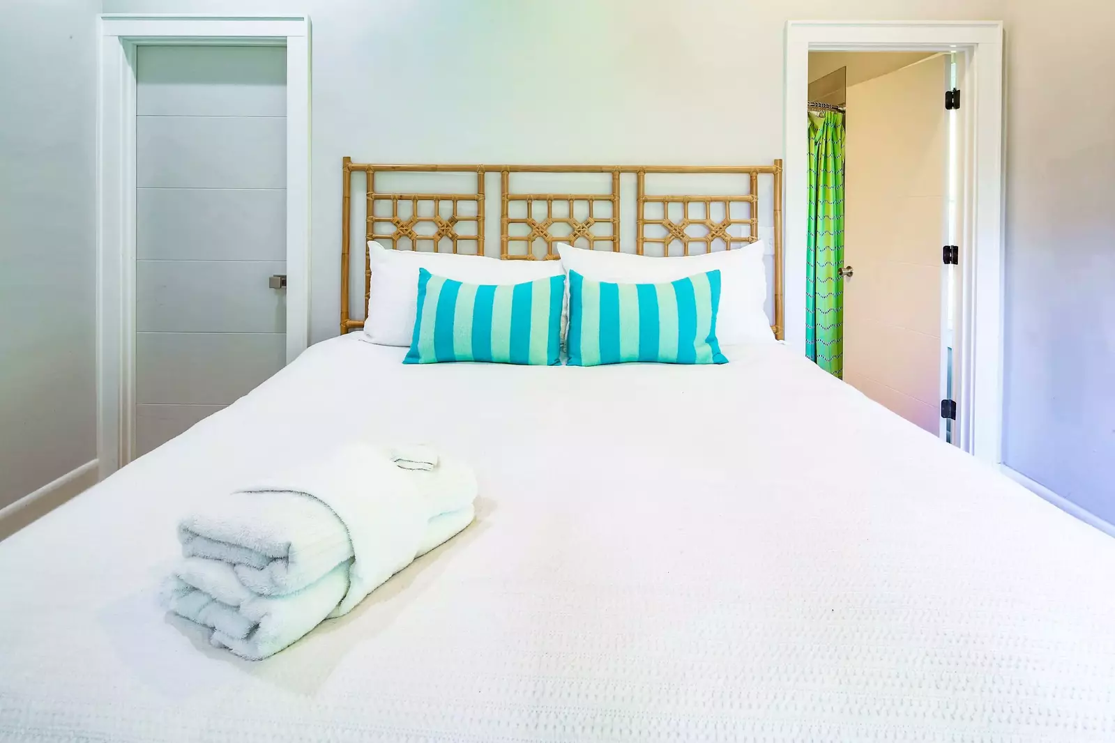 There is a closet to the left of the bed and an en suite bathroom to the right of the bed.