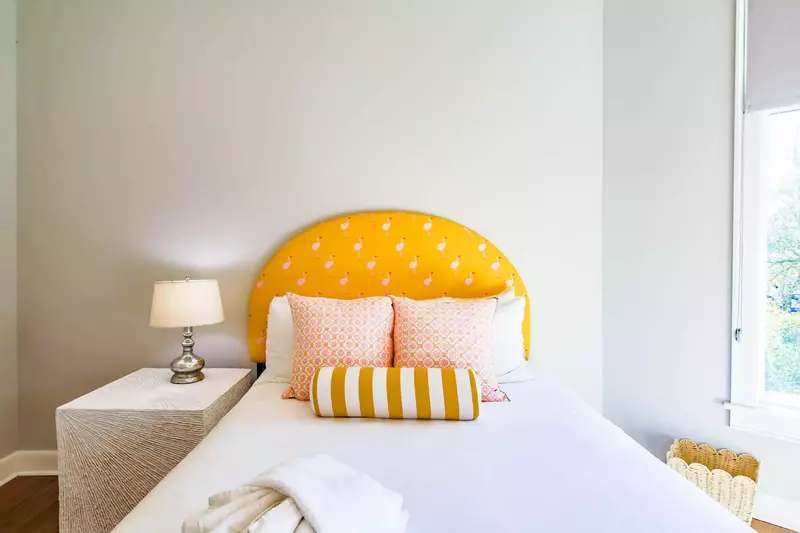 The queen bedroom, which is located on the home's upper level, features a queen bed and night stand with reading lamp.